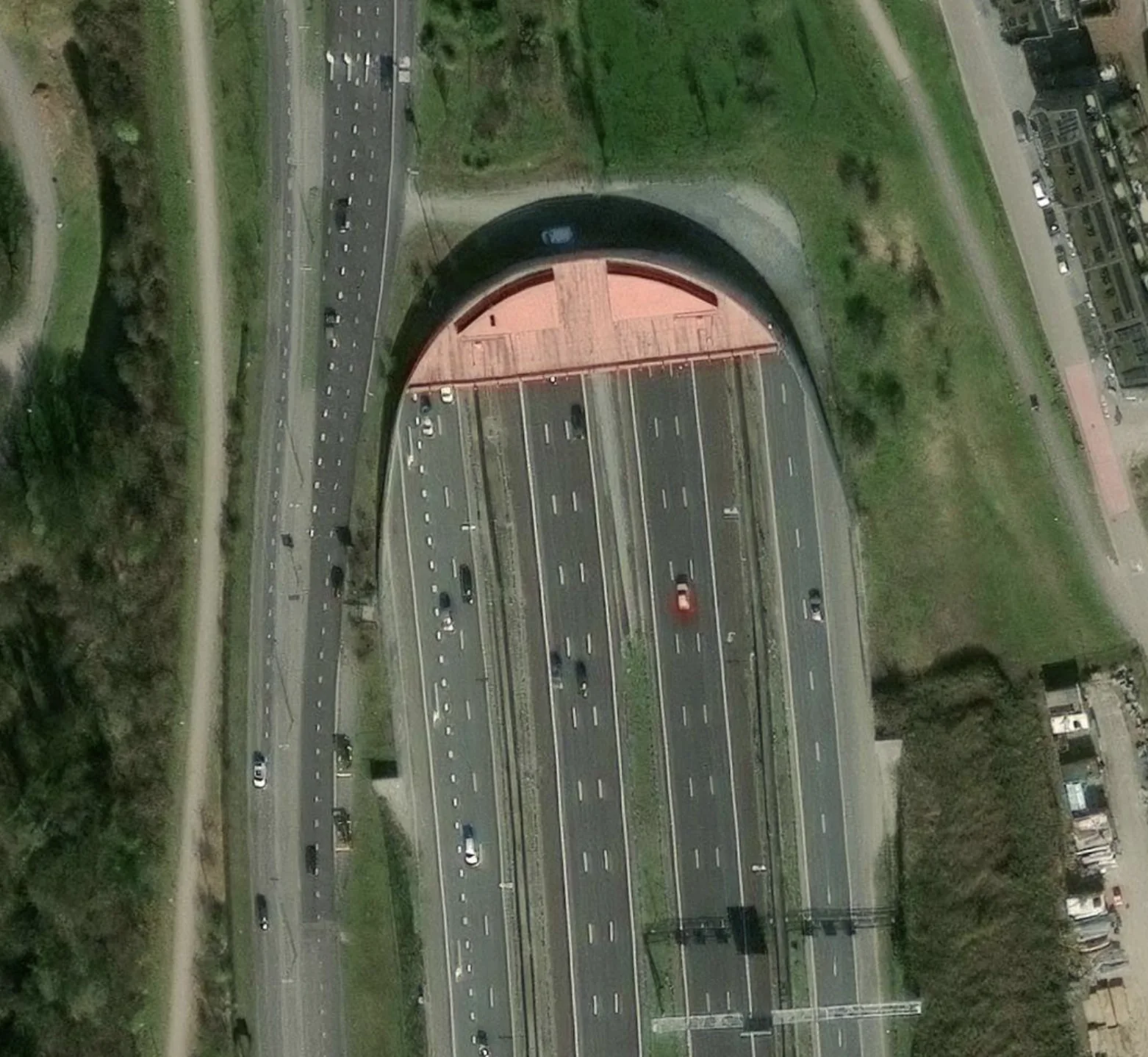 Aerial view of closely spaced parallel roads and a bridge, illustrating ambiguity when matching GPS traces.